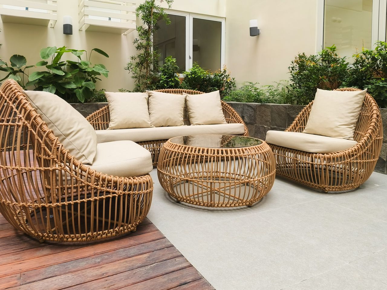 about-img Outdoor seating with rattan furniture set in a lush garden patio, ideal for relaxation and gatherings.